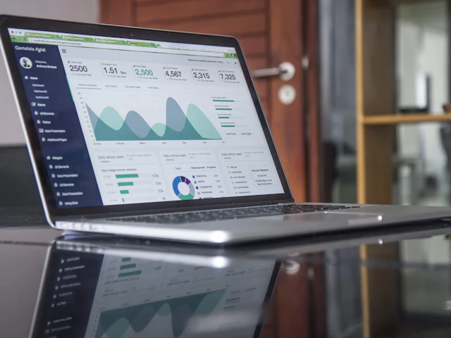 A laptop showing website traffic charts and analytics